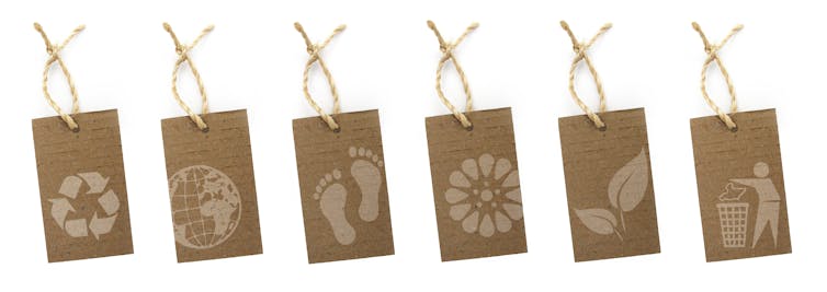 white background, six brown labels with eco images on eg footprint, recycling triangle, flower