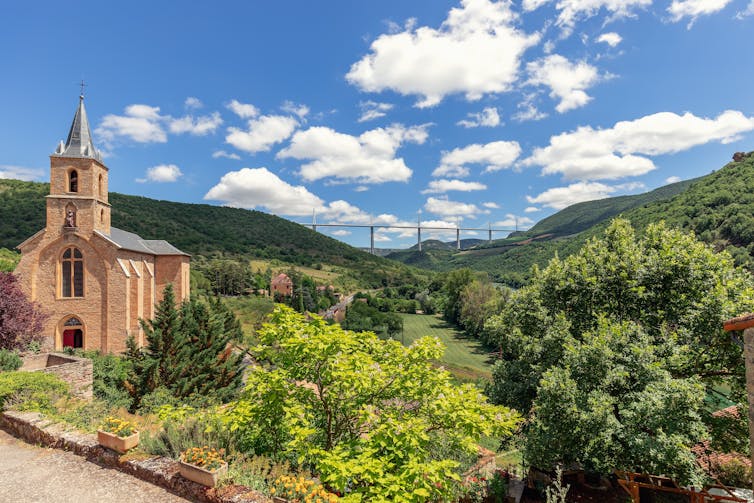 small church with huge bridge in the background