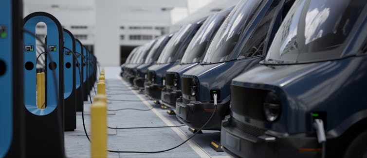 Electric vehicles lined up and being charged