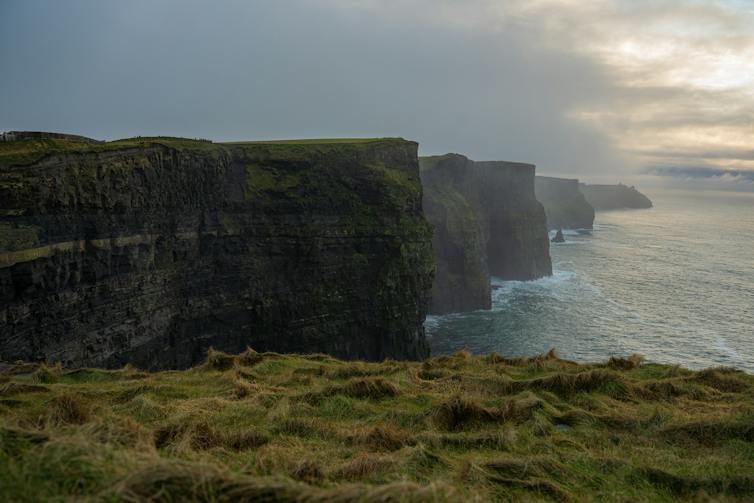 Big cliffs tower above the sea